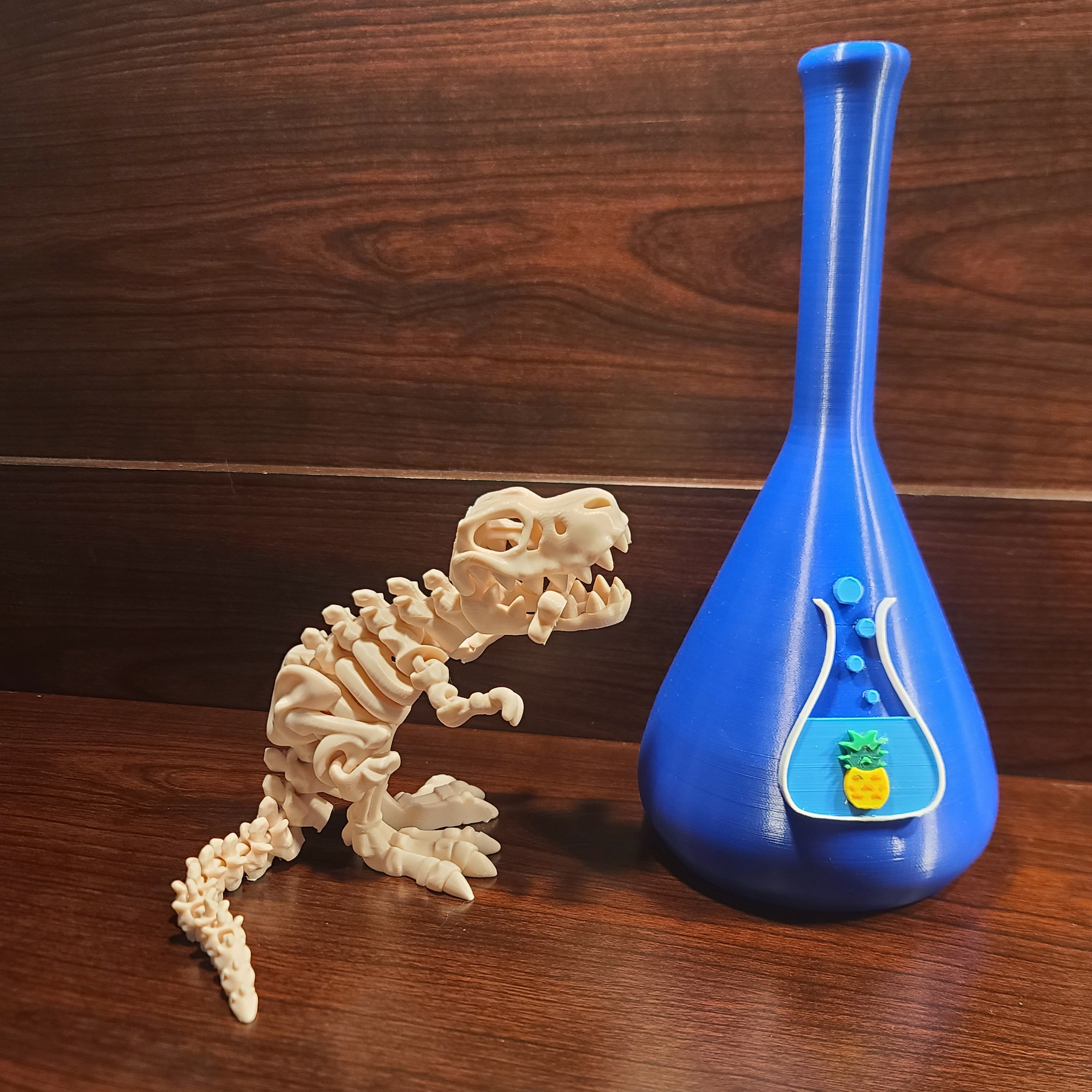 White dinosaur skeleton with a bone in the mouth. Wood background. Blue beaker with chuganations logo nearby.