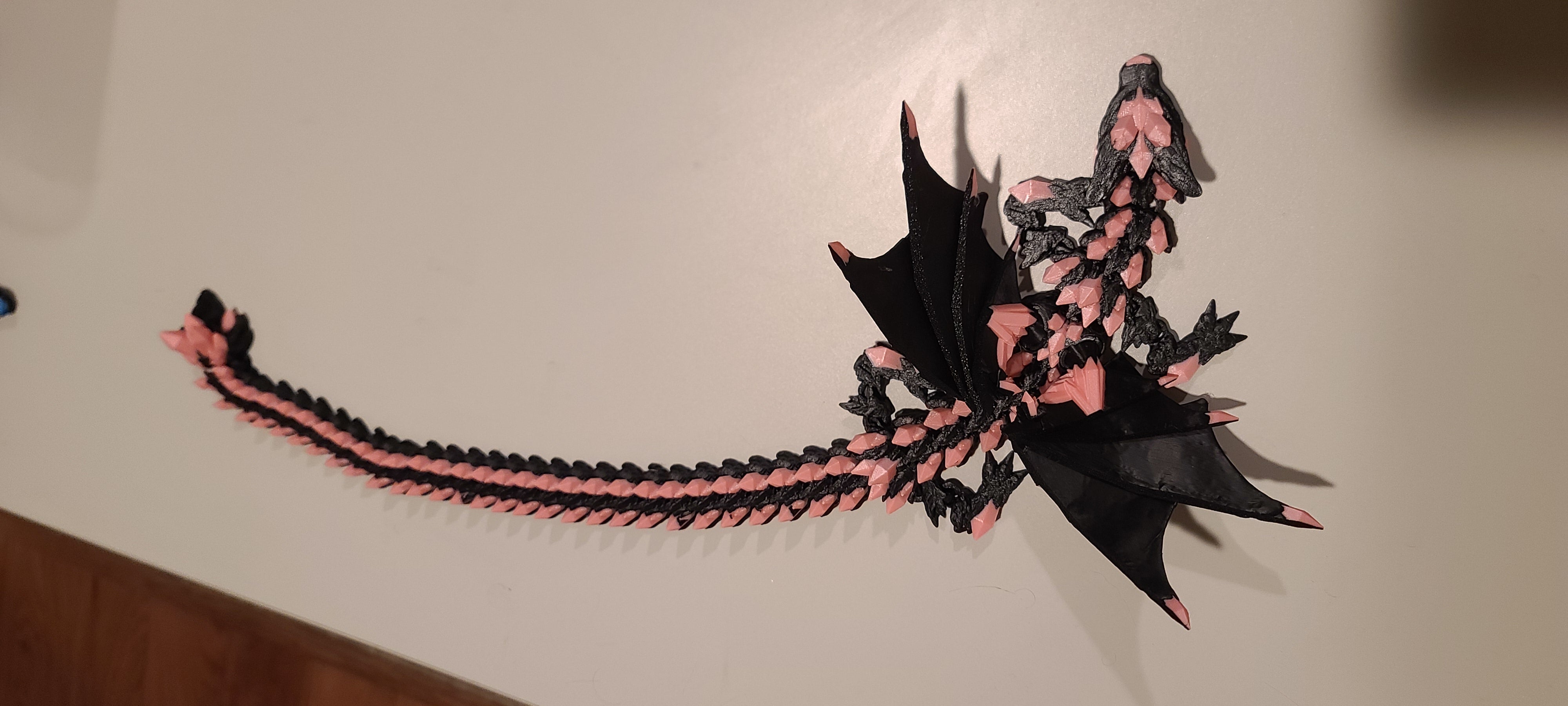 Peach and black dragon on a white background.