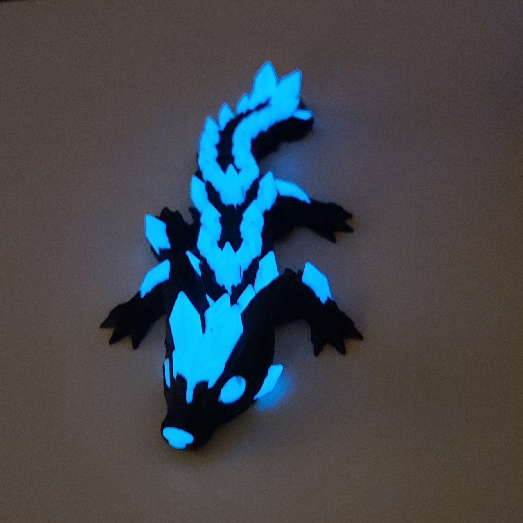 Dark dragon with glowing blue crystal features.