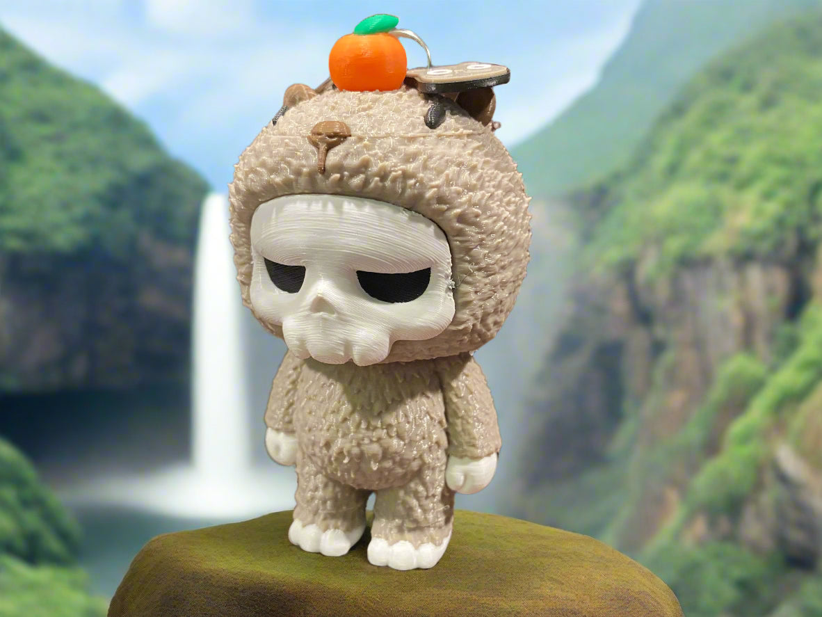 Toy figure with a skull face and capybara costume on a wooden surface