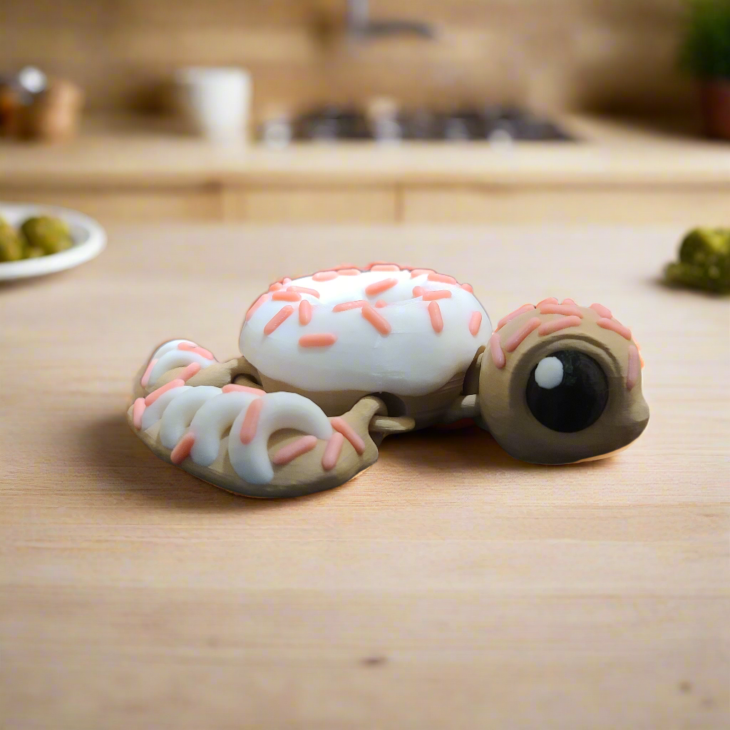 turtle with a doughnut shell with icing and pink sprinkles that glow in the dark.