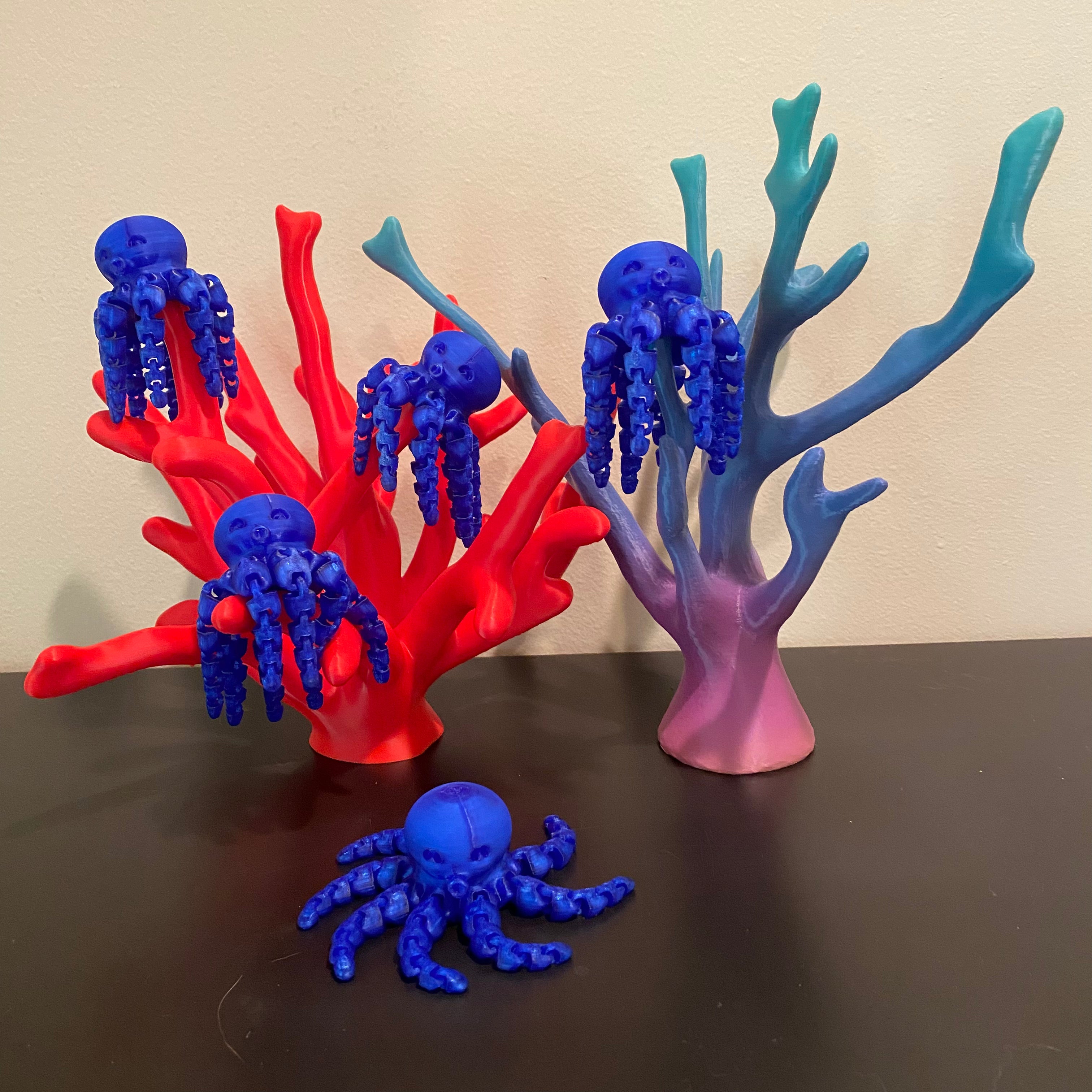 deep blue octopi on a corral reef. All of the items in the photo were manufactured by Chuganation's 3D Lab.