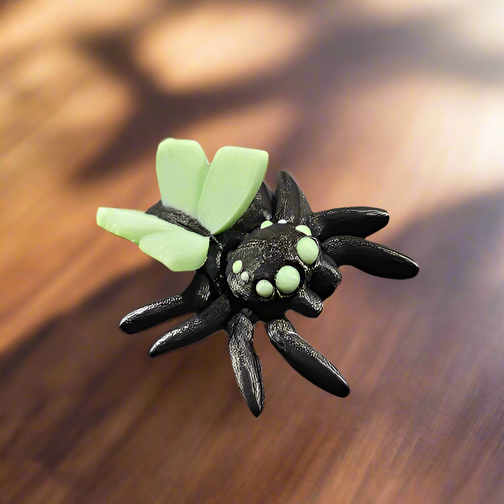 spider with fairy butterfly wings on a walnut table
