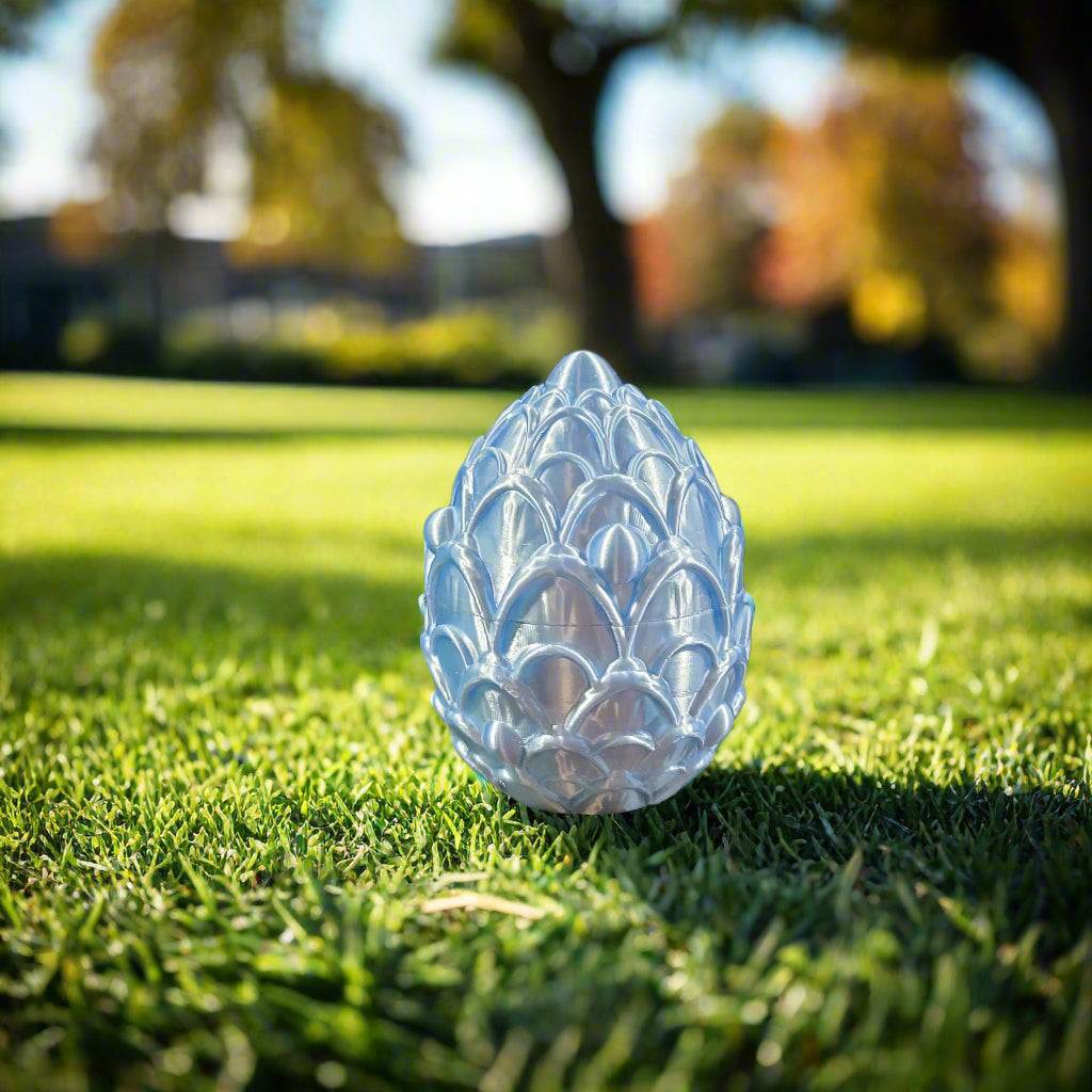 baby blue egg adorned with cookie decorations in a park environment