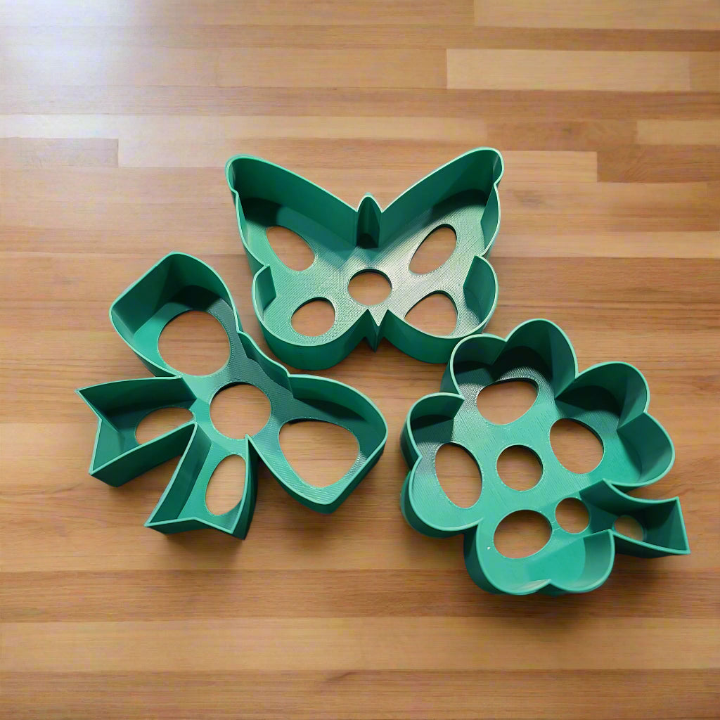 large cookie cutters in various shapes. butterfly, bowtie, and shamrock