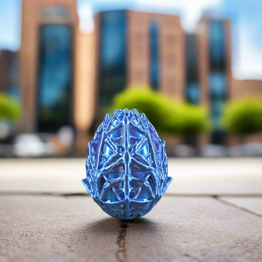 deep blue webbed egg, egg covered in cob webs.