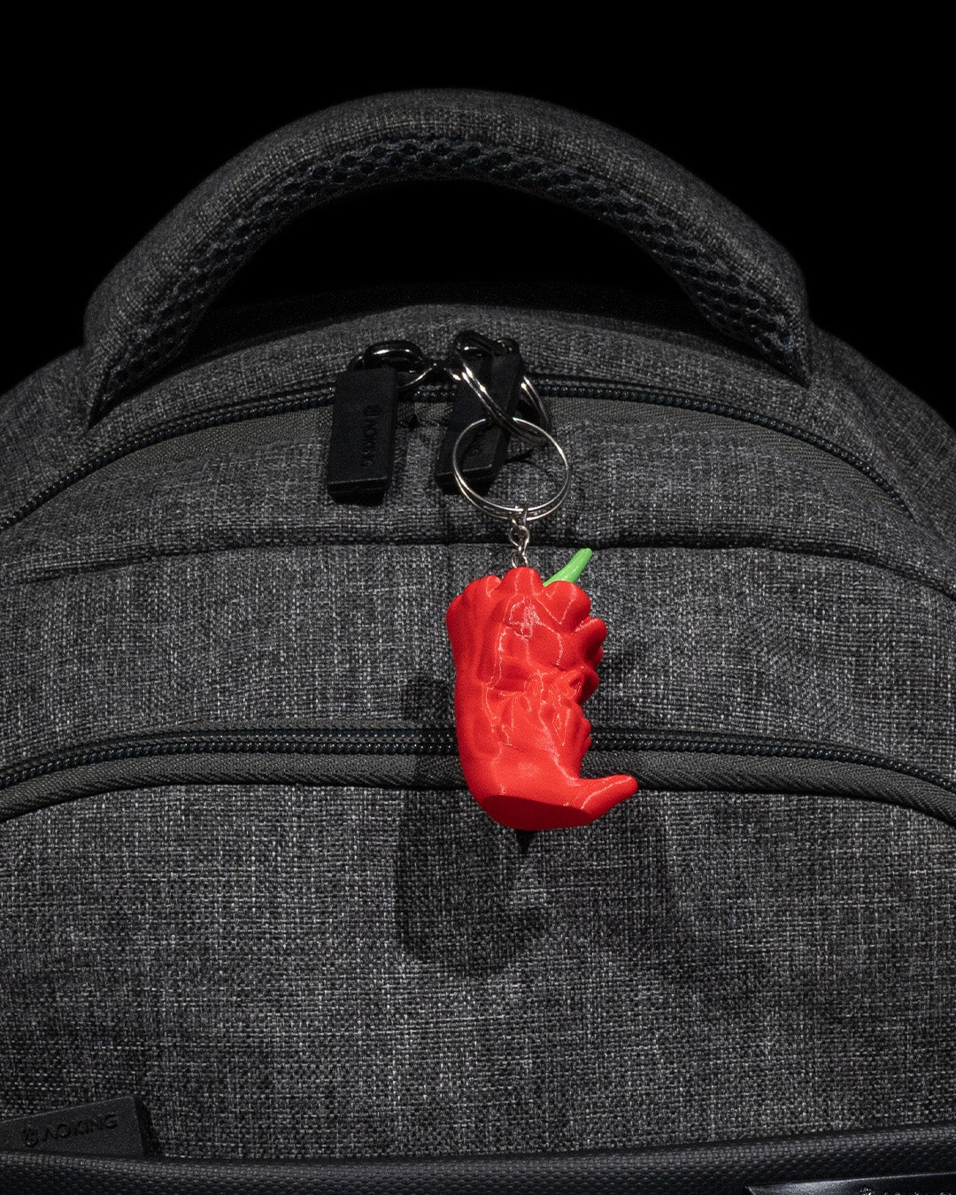 Another ange of the carolina grim reaper keychain manufactured by chuganation's 3d lab. on a backpack but not showcasing the quick clip that comes with the keychain.