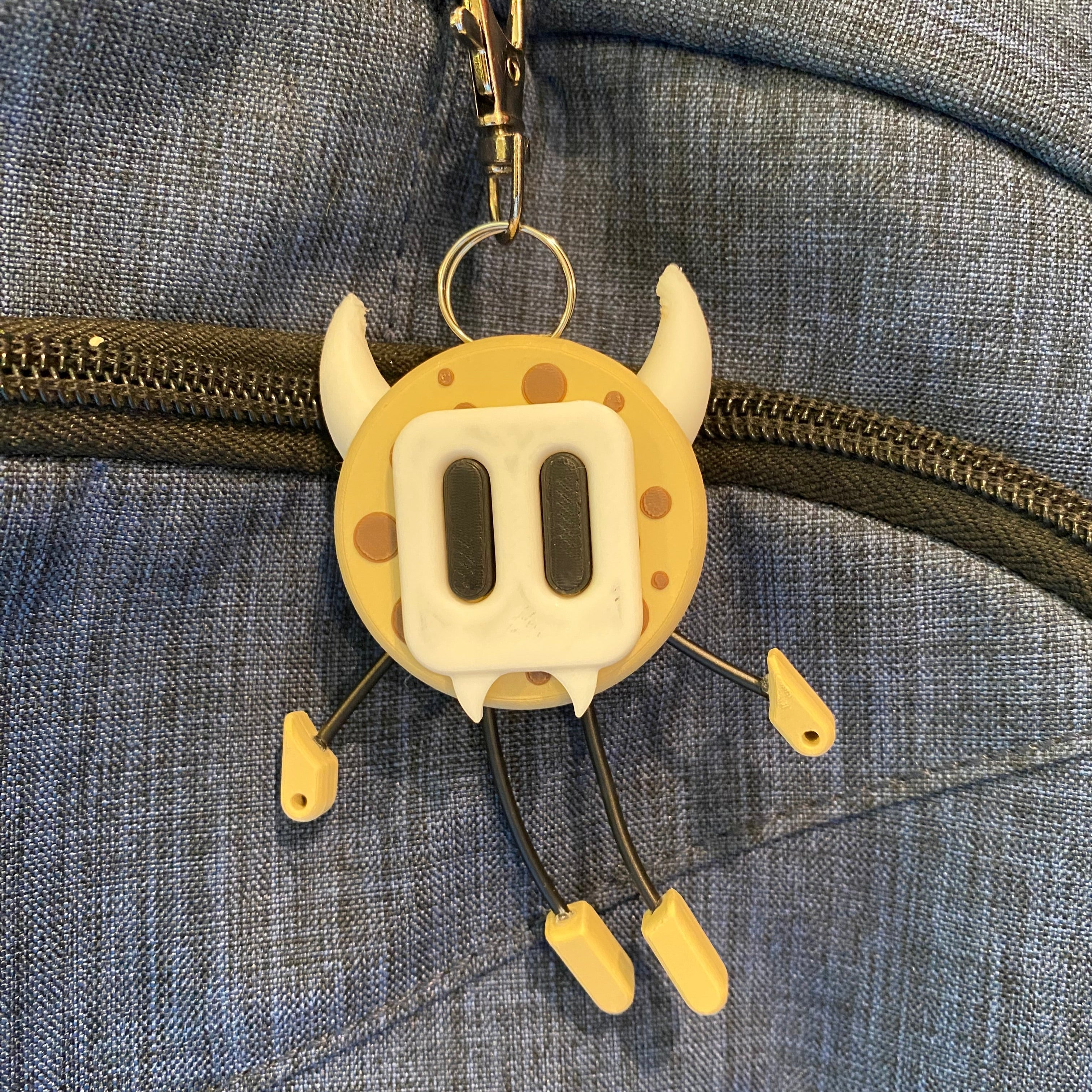 cookie shaped keychain wearing a cute mask. 