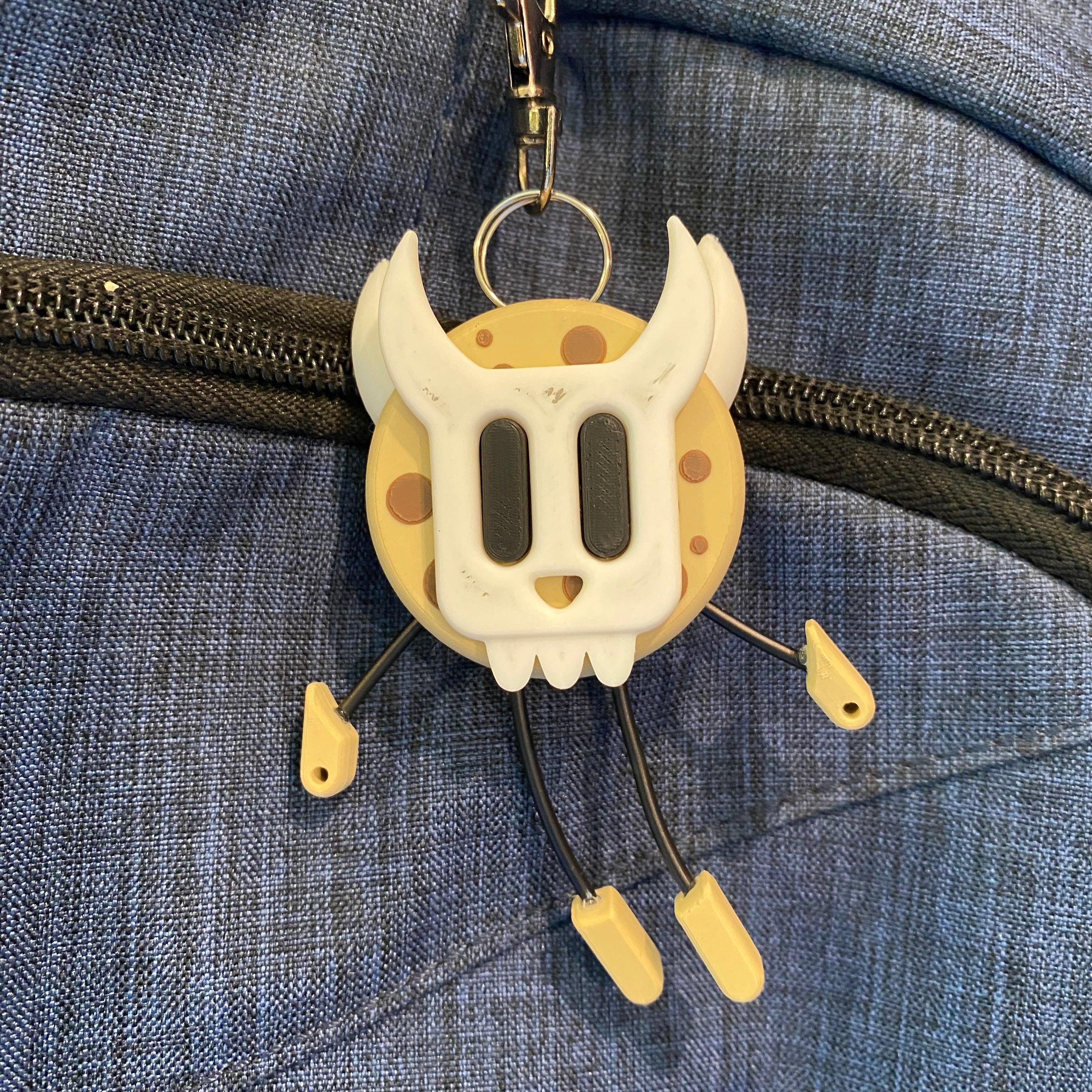 Cookie shaped keychain wearing a mask