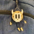 Cookie shaped keychain wearing a mask.