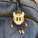 Cookie shaped keychain wearing a mask.