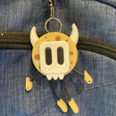 Cookie shaped keychain wearing a mask.