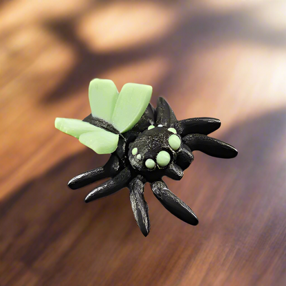 spider with fairy butterfly wings on a walnut table 