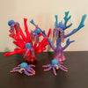 6 rainbow octopi are resting on a couple of corral reefs. All of the items in the photo are manufactured by Chuganation's 3D Lab.